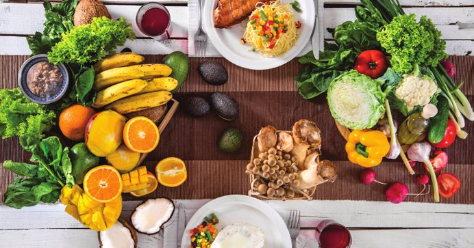 Fresh fruit, vegetables and healthy dishes on a table